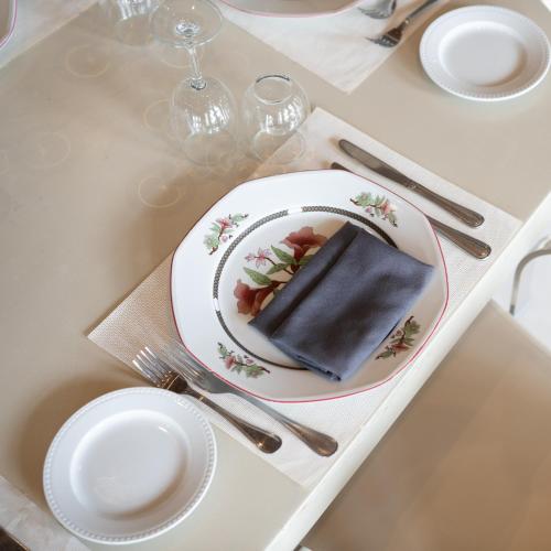 a white table with a plate of food on it at Pickalbatros Hôtel Du Golf - Adults Friendly 16 Years Plus- All-Inclusive in Marrakech