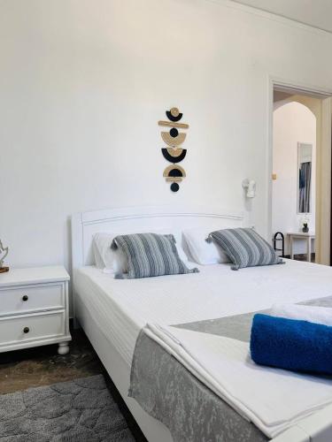a bedroom with two beds with towels on the wall at Desire Apartments in Kato Gouves