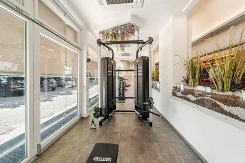 a gym with two treadmills in a building at Hotel Fiera Wellness & Spa in Bologna