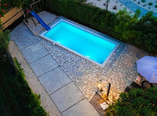 an overhead view of a swimming pool on a patio at Holiday Home Krnić in Šibenik