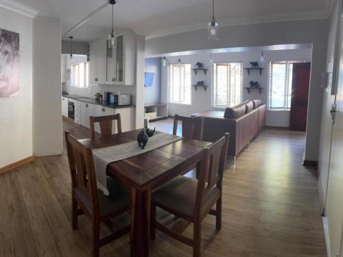 a kitchen and dining room with a table and chairs at Big 5 Cottage in Pretoria