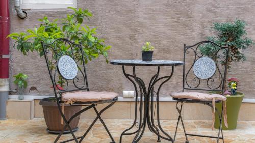 a table and two chairs with plants on them at Marita Hotel in Tbilisi City