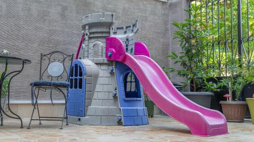 a plastic castle playset with a slide at Marita Hotel in Tbilisi City