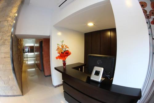 a lobby with a desk with a computer and flowers at Lecer Apart in Buenos Aires