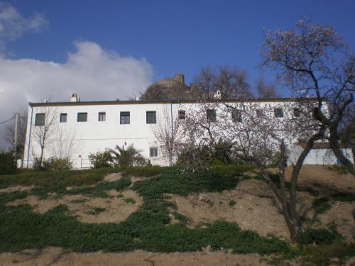a white building sitting on top of a hill at Apartamentos Rurales El Cañuelo de Carcabuey in Carcabuey