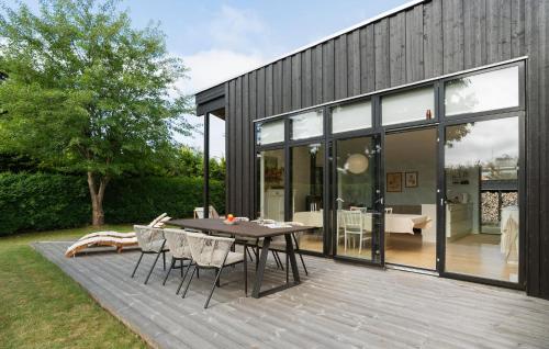 Un patio con una mesa y sillas en una terraza. en 3 Bedroom Stunning Home In Børkop, en Børkop