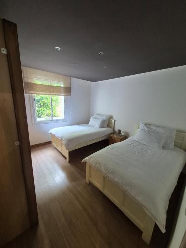 a bedroom with two beds and a window at Hassan Rabat Centre JABLI Street in Rabat
