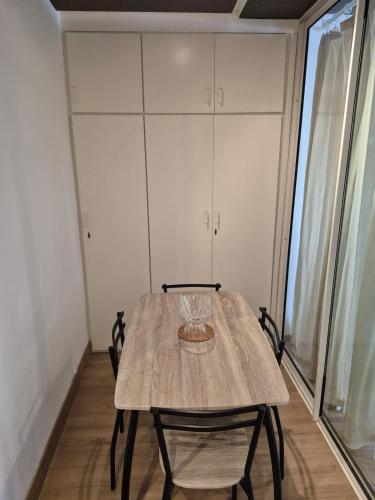 a wooden table with two chairs in a room at Hassan Rabat Centre JABLI Street in Rabat