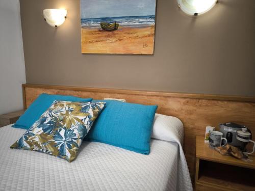a bedroom with a bed with a camera on it at Hostería VISTAPARK in El Astillero