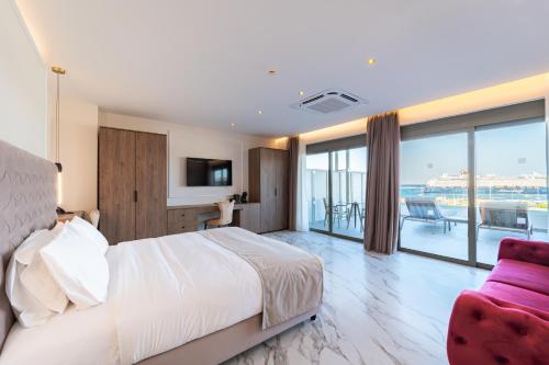 a hotel room with a bed and a couch at Philia Center Suites in Rhodes Town