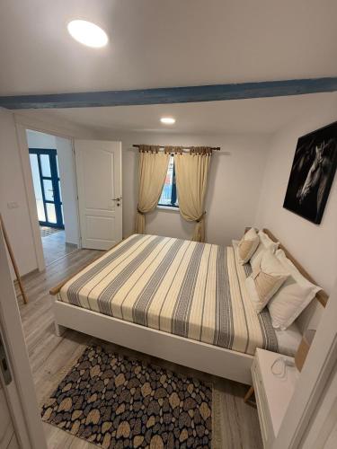 a bedroom with a large bed in a room at Casa lui Matei Murighiol in Murighiol