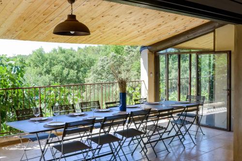 d'une grande table bleue et de chaises sur un balcon. dans l'établissement Les Gardis Family house for ideal refuge in Provence !, à Cadenet