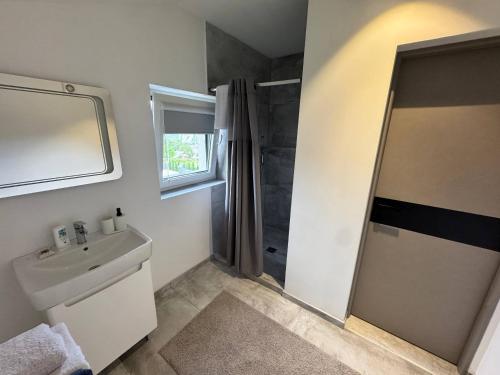 a bathroom with a sink and a shower at Chicago Hotel in Yaremche