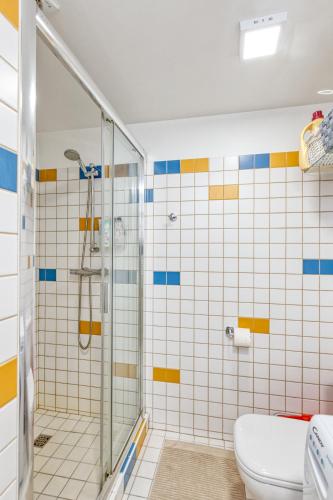 a bathroom with a shower and a toilet at Vienības Family. in Jūrmala