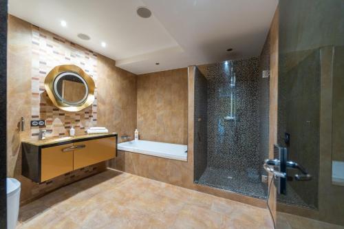 a bathroom with a shower and a sink and a tub at Luxury Vacation Villa in Marbella