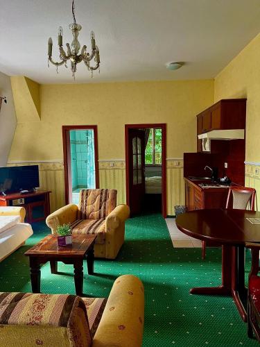 a living room with a couch and a table at Schloss Zehdenick in Zehdenick