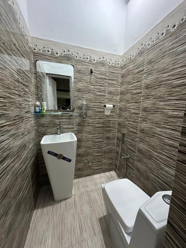 a bathroom with a toilet and a sink at Luxurious 5 Bedroom Mansion Upper Portion Near Gerry Visa Park Road Islamabad in Islamabad