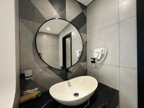 a bathroom with a sink and a mirror at LION 17 Hotel in Can Tho
