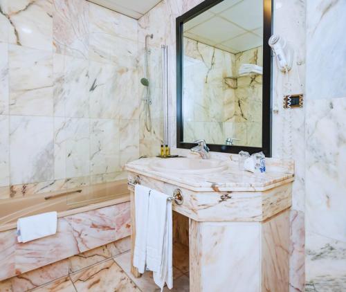 a bathroom with a sink and a mirror at Hotel Condestable Iranzo in Jaén