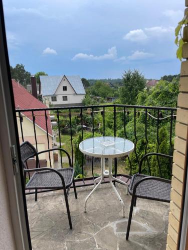 a patio with a table and chairs on a balcony at Hotel Domashnii in Zhytomyr