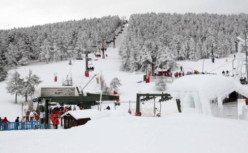 a group of people on a ski lift in the snow at Casa Senderuela by CARDI Suites in Valdelinares
