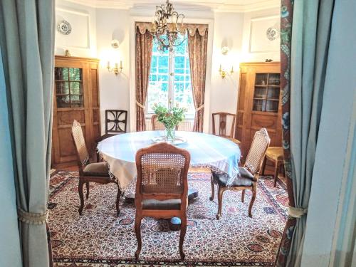 a dining room with a table and chairs at Ferienhaus Dr. Müller in Meißen