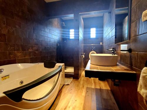a bathroom with a tub and a sink at VEZO BEACH HOTEL Morondava in Morondava
