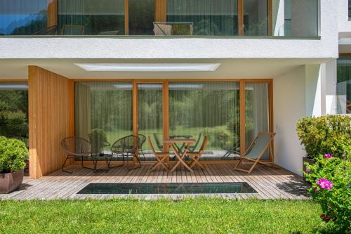 a patio with chairs and a table on a house at Greva Apartments 1 in Santa Cristina in Val Gardena