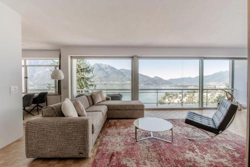 a living room with a couch and a table at Chiar di Luna by Quokka 360 - loft with view of Lake Maggiore in Minusio