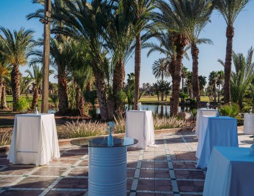 a table set up for a wedding with palm trees at Pickalbatros Hôtel Du Golf - Adults Friendly 16 Years Plus- All-Inclusive in Marrakech