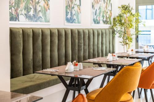 a row of tables and chairs in a restaurant at Philia Center Suites in Rhodes Town
