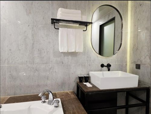 a bathroom with a sink and a mirror at Blueduck hotel in Seoul
