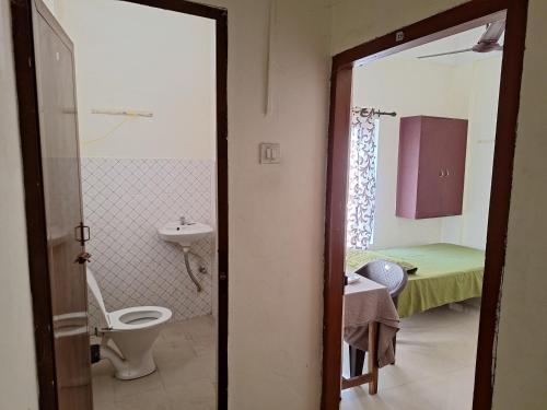 a bathroom with a toilet and a sink at Jays Residency - Trinity Sapphire Trivandrum in Trivandrum