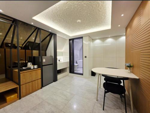 a kitchen with a table and a refrigerator at Blueduck hotel in Seoul