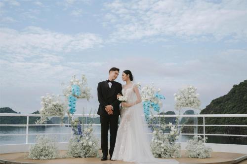a bride and groom pose for a picture at their wedding at Radisson Blu Ha Long Bay in Ha Long