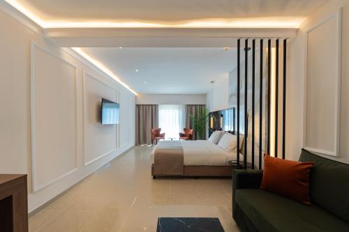 a hotel room with a bed and a couch at Philia Center Suites in Rhodes Town
