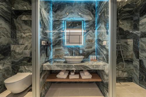 a bathroom with a sink and a toilet at Philia Center Suites in Rhodes Town