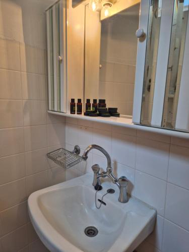 a white sink in a bathroom with a mirror at Urban Roof Studio in Kavala