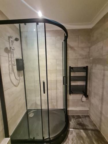 a shower with a glass enclosure in a bathroom at La Mouette in Mevagissey