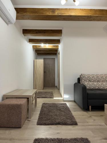 a living room with a couch and a table at Pensiunea Kacsó in Măgherani