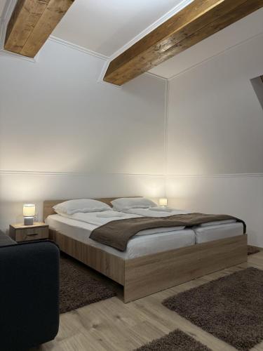 a bedroom with a large bed and two lamps at Pensiunea Kacsó in Măgherani
