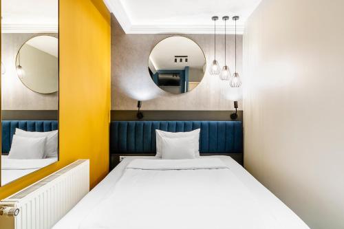 Postel nebo postele na pokoji v ubytování Alta Moda Fashion Hotel