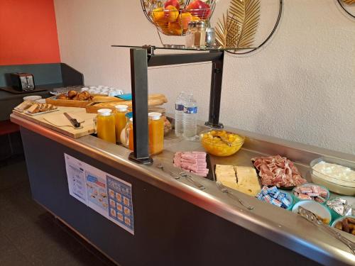 a buffet line with food on top of it at Hotel Le Saint Aubin in Gournay-en-Bray