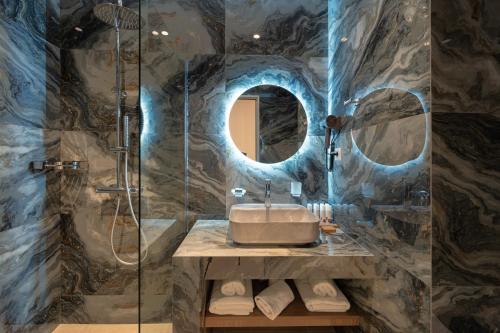 a bathroom with a sink and a shower at Philia Center Suites in Rhodes Town