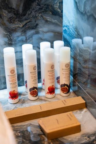 a group of four bottles of lip moisturizers on a table at Philia Center Suites in Rhodes Town