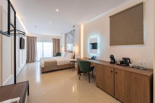 a large hotel room with a bed and a desk at Philia Center Suites in Rhodes Town