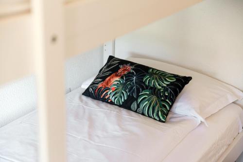a pillow sitting on top of a bed at Casa Ortensia by Quokka 360 - Cozy house with garden in Monteggio