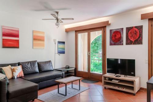 a living room with a couch and a tv at Casa Ortensia by Quokka 360 - Cozy house with garden in Monteggio