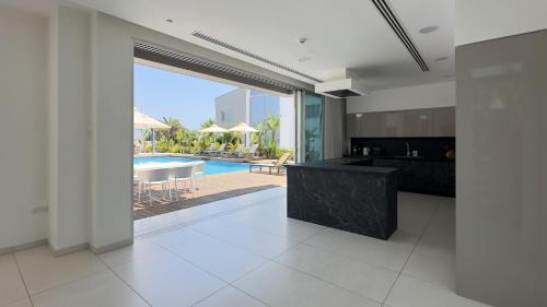 an open kitchen with a view of a pool at Cove Seaview Villas - Neptune in Ayia Napa