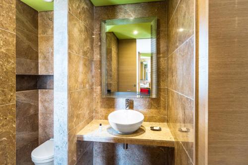 a bathroom with a sink and a toilet at Pickalbatros Hôtel Du Golf - Adults Friendly 16 Years Plus- All-Inclusive in Marrakech